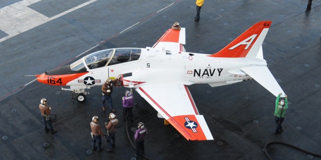 Sailors refuel a T-45 Goshawk assigned to Training Wing 1 on the flight deck of the USS George H.W. Bush.