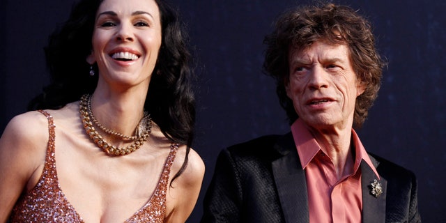 February 27, 2011. Rock musician Mick Jagger (R) and model L'Wren Scott arrive at the 2011 Vanity Fair Oscar party in West Hollywood, California.