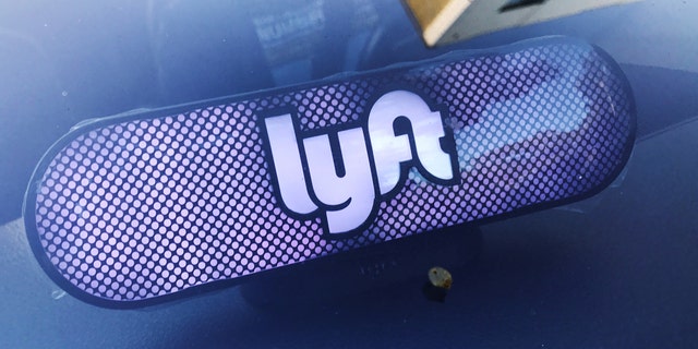 A Lyft sign is seen inside a car in Los Angeles.