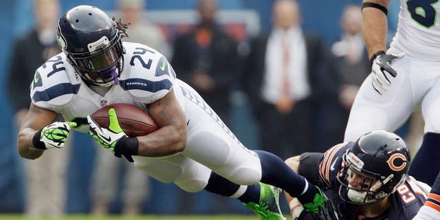 Seattle Seahawks running back Marshawn Lynch (24) is tackled by Chicago Bears free safety Chris Conte in the first half of an NFL football game in Chicago, Sunday, Dec. 2, 2012. (AP Photo/Nam Y. Huh)