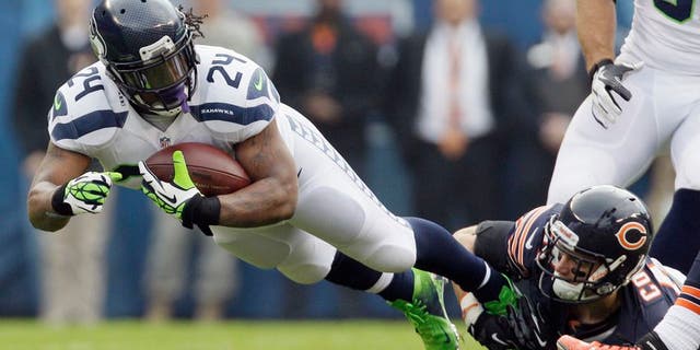 Seattle Seahawks running back Marshawn Lynch (24) is tackled by Chicago Bears free safety Chris Conte in the first half of an NFL football game in Chicago, Sunday, Dec. 2, 2012. (AP Photo/Nam Y. Huh)