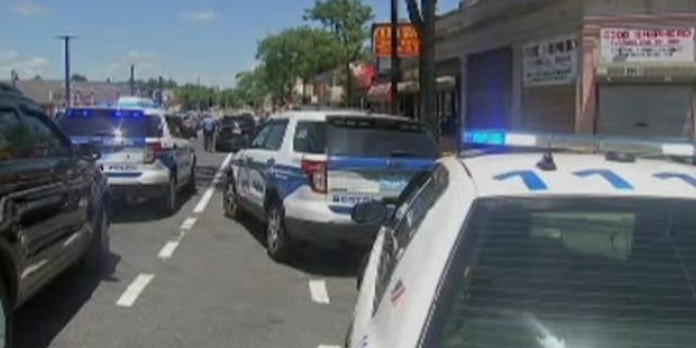 Police at the scene outside the barber shop.