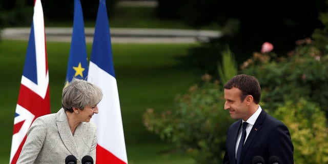 French President Emmanuel Macron, right, and Britain's Prime Minister Theresa May, spoke at a joint press conference, after a meeting, at the Elysee Palace, in Paris, Tuesday, June 13, 2017. (AP Photo/Thibault Camus)