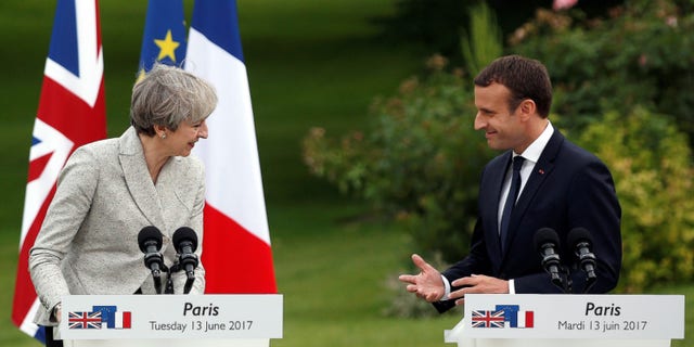 French President Emmanuel Macron, right, and Britain's Prime Minister Theresa May, spoke at a joint press conference, after a meeting, at the Elysee Palace, in Paris, Tuesday, June 13, 2017. (AP Photo/Thibault Camus)