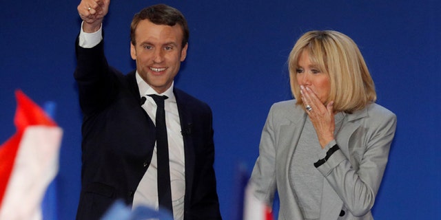 Emmanuel Macron, head of the political movement En Marche !, or Onwards !, and candidate for the 2017 French presidential election, arrives on stage with his wife Brigitte Trogneux to deliver a speech at the Parc des Expositions hall in Paris after early results in the first round of 2017 French presidential election, France, April 23, 2017.