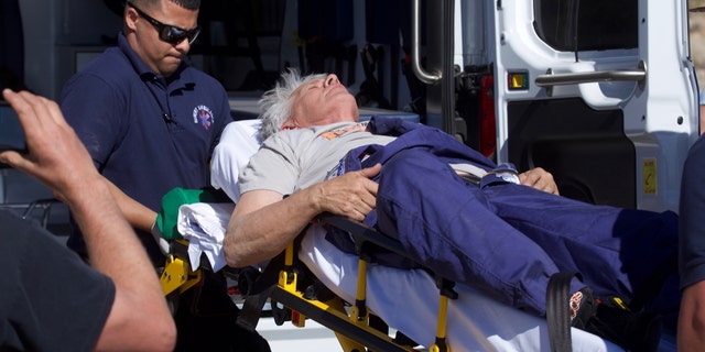 “Mad” Mike Hughes is carried on a stretcher after his home-made rocket launched and returned to the ground near Amboy, Calif., on Saturday, March 24, 2018.