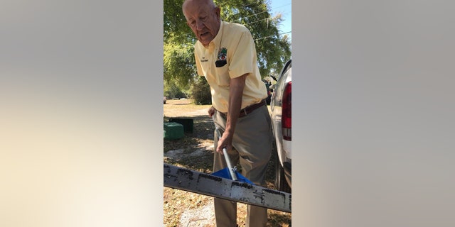 Oak Hill Mayor Doug Gibson collects nails using a magnetic roller the city just purchased to deal with the problem.