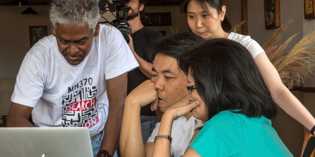 V.P.R. Nathan, left, whose wife, Anne Daisy, was on board the missing Malaysia plane, talks with other relatives of passengers during their meeting at a hotel in Antananarivo, Madagascar, Sunday, Dec.4, 2016.