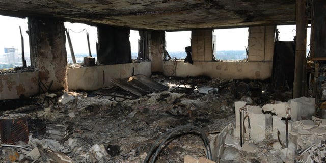 In this photo released by the Metropolitan Police on Sunday, June 18, 2017, a view of an apartment in the Grenfell Tower after fire engulfed the 24-storey building, in London. ??Experts believe the exterior cladding, which contained insulation, helped spread the flames quickly up the outside of the public housing tower early Wednesday morning. Some said they had never seen a building fire advance so quickly. The 24-story tower that once housed up to 600 people in 120 apartments is now a charred ruin. (Metropolitan Police via AP)