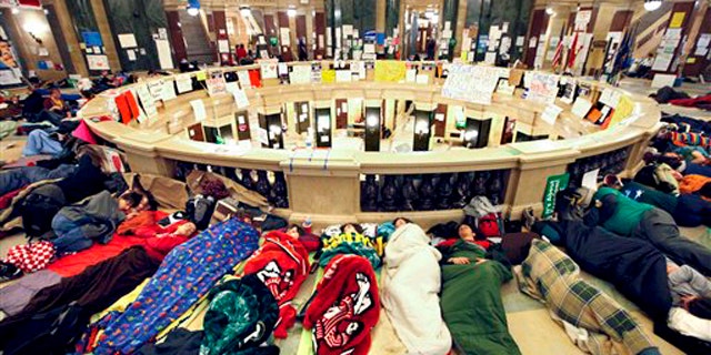 Opponents of Wisconsin Gov. Scott Walker's budget bill sleep in the rotunda of the Wisconsin State Capitol Feb. 22.