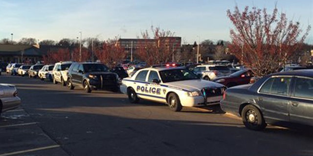 In this photo provided by NBC15 Madison, authorities respond to reports of shots fired at the East Towne Mall in Madison, Wis., Saturday, Dec. 19, 2015. (Sharon Yoo/NBC15 Madison via AP) MANDATORY CREDIT