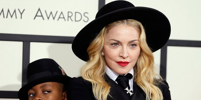 January 26, 2014. Madonna and her son, David Ritchie, arrive at the 56th annual Grammy Awards in Los Angeles, California.