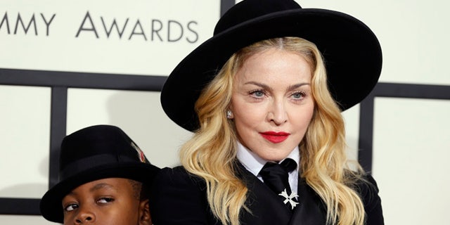 January 26, 2014. Madonna and her son, David Ritchie, arrive at the 56th annual Grammy Awards in Los Angeles, California.