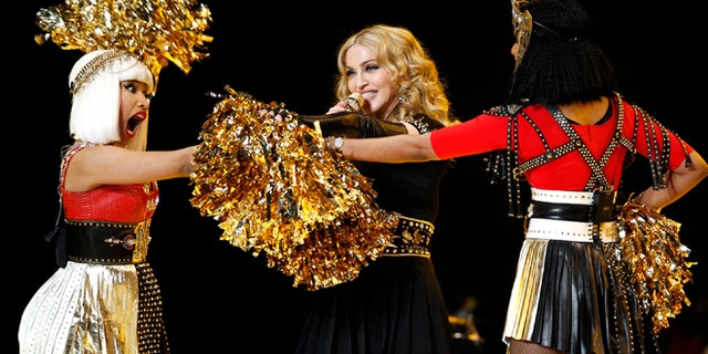 Madonna performs during the halftime show with Nicki Minaj (L) and M.I.A. in the NFL Super Bowl XLVI football game in Indianapolis, Indiana, February 5, 2012. REUTERS/Mike Segar (UNITED STATES - Tags: SPORT FOOTBALL) - RTR2XDU8