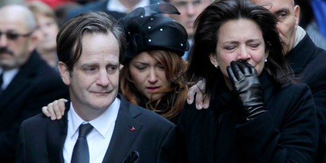 Jan. 5, 2012: Matthew Badger, left, and Madonna Badger, the parents of three children that were killed in a fire, react as their caskets are carried into a church during the funeral in New York.
