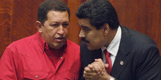 FILE: President Hugo Chavez, left, talks to then Foreign Minister Nicolas Maduro at the University of Uruguay in Montevideo, Uruguay.