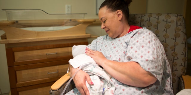 Beverly Thorton, a volunteer at Magee-Womens Hospital of UPMC in Pittsburgh, cuddles babies addicted to opioids and often sings to soothe them.