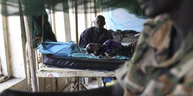 March 15, 2014: A child sick with malaria and from malnutrition lies on a bed in a hospital in Bor.