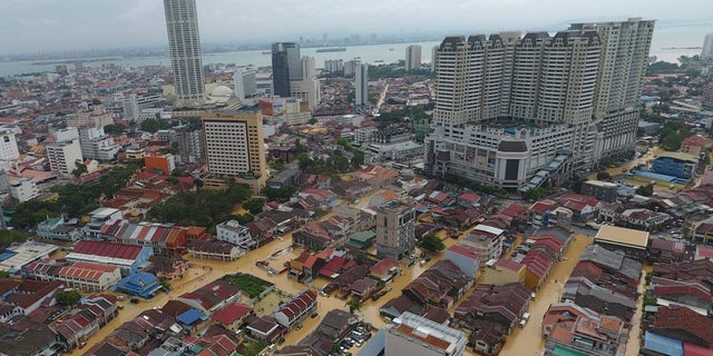 An aerial view shows a flooded George Town city in Penang, Malaysia, Sunday, Nov. 5, 2017. A northern Malaysian state has been paralyzed by a severe storm that led to two deaths and some 2,000 people evacuated in the worst flooding in years, officials say. (AP Photo)