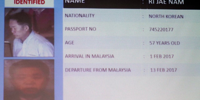 Information about one of the suspects North Korean Ri Jae Nam, is displayed during a press conference by Malaysia Deputy National Police Chief Noor Rashid Ibrahim, not show, at the Bukit Aman national police headquarters in Kuala Lumpur, Malaysia, Sunday, Feb. 19, 2017. Malaysia's police are looking for four more North Korean suspects who they say left the country the same day the North Korean leader's brother died after being attacked at the Kuala Lumpur airport. (AP Photo/Vincent Thian)