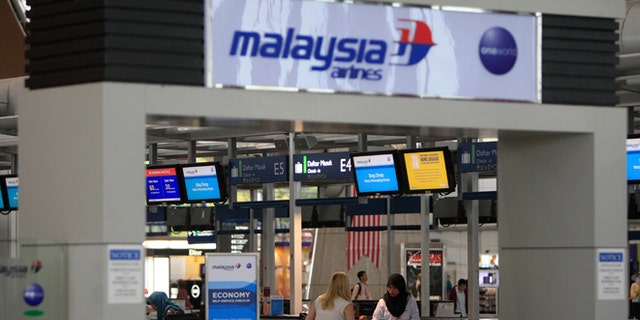 Aug. 29, 2014: Passengers are ready to check in at a departure lobby at Kuala Lumpur International Airport in Sepang, Malaysia. Malaysia Airlines will cut 6,000 workers as part of an overhaul announced Friday to revive its damaged brand after being hit by double passenger jet disasters.(AP/Lai Seng Sin)
