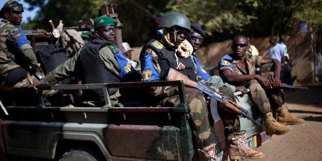 FILE - In this file photo taken on Sunday Nov. 24, 2013, the Malian army patrol the streets of Gao, Northern Mali. A doctor in northern Mali says Wednesday, Jan. 18, 2017 that at least seven people have been killed and more than 50 wounded in an attack on an installation for various armed groups, and the toll is certain to rise. (AP Photo/Jerome Delay, File)