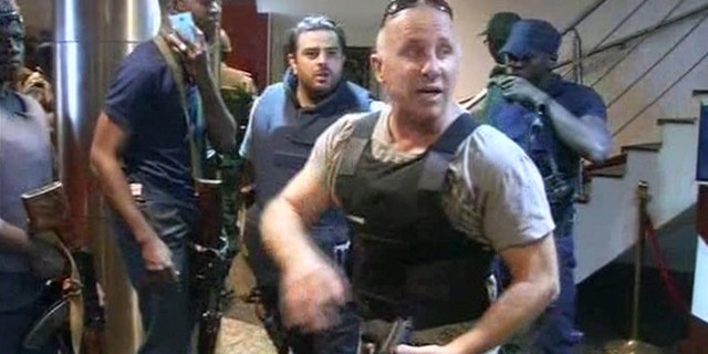 Nov. 20, 2015: In this TV image taken from Mali TV ORTM, a security officer gives instructions to other security forces inside the Radisson Blu Hotel in Bamako, Mali.