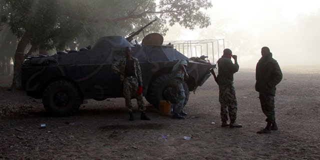 Jan. 20, 2013: Malian soldiers stand by their APC as a French Puma transport helicopter lands to test the field in the center of Niono, some 400 kms (300 miles) North of the capital Bamako.