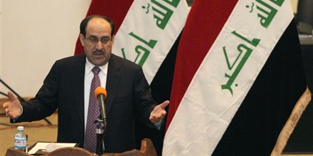 Iraqi Prime Minister Nouri al-Maliki speaks to Iraqi lawmakers before submitting his new government for approval in Baghdad, Iraq, Dec. 21.