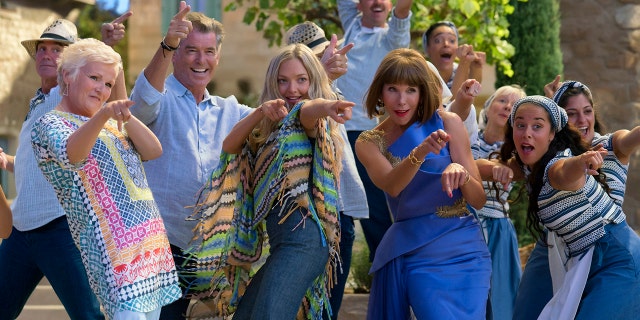 This image released by Universal Pictures shows, foreground from left, Julie Walters, Pierce Brosnan, Amana Seyfried and Christine Baranski in a scene from "Mamma Mia! Here We Go Again." (Jonathan Prime/Universal Pictures via AP)