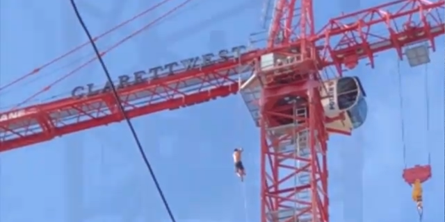 Man with American flag on crane