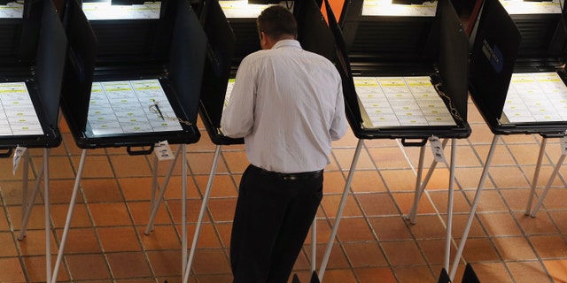 MIAMI, FL - APRIL 29: A voter fills out a ballot during the early voting period on a ballot issue to decide if the Miami Dolphins and their owner Stephen Ross will be able to tap into $289 million in public funding that the team is seeking to help renovate their stadium on April 29, 2013 in Miami, Florida. Early voting started without a clear understanding if it will even be counted because the stadium renovation plan is dependent on the Florida legislature voting to increase the Miami-Dade mainland hotel tax rate from 6 to 7 percent and they have not yet decided to vote on that issue themselves. (Photo by Joe Raedle/Getty Images)