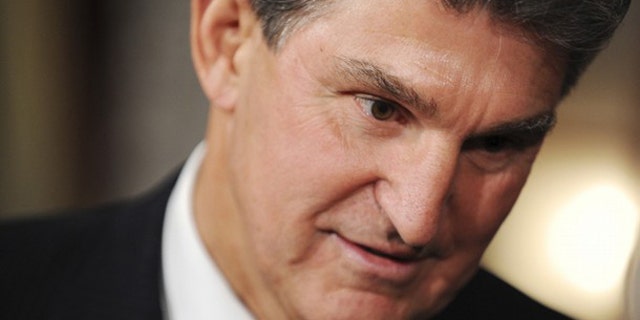 In this Nov. 15, 2010 photo, Sen. Joe Manchin talks with family members after being ceremonially sworn in at the U.S. Capitol in Washington.