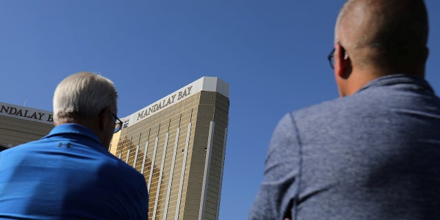 Tourists look up at the broken windows on the Mandalay Bay hotel where shooter Stephen Paddock conducted his mass shooting along the Las Vegas Strip in Las Vegas, Nev., October 4, 2017. (Reuters)