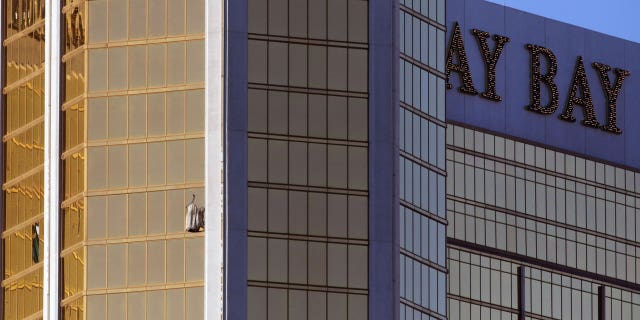 Drapes billow out of a broken window at the Mandalay Bay resort and casino Monday, Oct. 2, 2017, on the Las Vegas Strip following a deadly shooting at a music festival in Las Vegas. A gunman was found dead inside a hotel room.