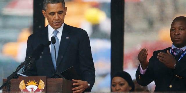 Dec. 10, 2013: President Barack Obama looks down as he stands next to the sign language interpreter as he makes his speech at the memorial service for former South African president Nelson Mandela at the FNB Stadium in Soweto near Johannesburg. South Africa's deaf federation said on Wednesday that the interpreter on stage for Mandela memorial was a "fake." (AP)