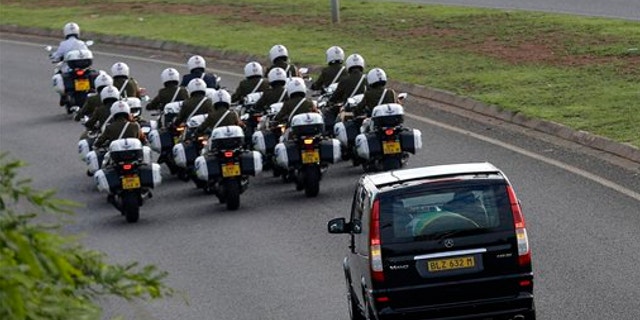 Dec. 14, 2013: Motorcycles escort a hearse carrying the casket of former South African President Nelson Mandela en route to Waterkloof Air Base on the outskirts of Pretoria, South Africa.