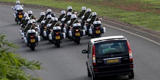 Dec. 14, 2013: Motorcycles escort a hearse carrying the casket of former South African President Nelson Mandela en route to Waterkloof Air Base on the outskirts of Pretoria, South Africa.