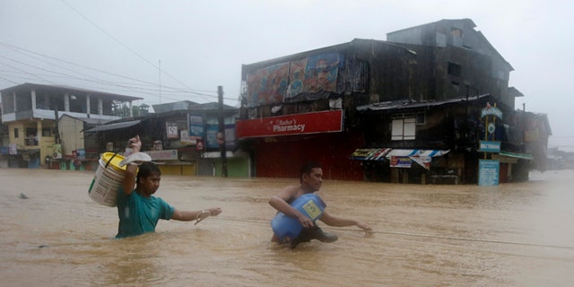 Sept. 19, 2014: Residents make their way through deep floodwaters after heavy monsoon rains spawned by Tropical Storm Fung-Wong flooded Marikina city, east of Manila, Philippines.