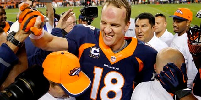 Oct. 19, 2014: Denver Broncos quarterback Peyton Manning (18) celebrates his 509th career touchdown pass with teammates during the first half of an NFL football game against the San Francisco 49ers.