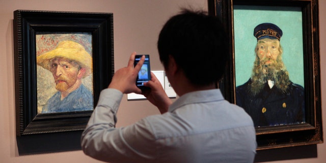 A visitor at the Detroit Institute of Arts museum uses his cell phone to take a picture of the "Self Portrait," painting by Vincent van Gogh. (REUTERS/Rebecca Cook)