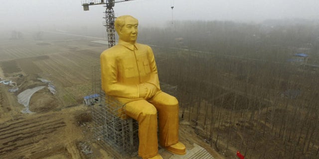 Jan. 4, 2016: A 120-foot tall gold-colored statue of former Chinese leader Mao Zedong is surrounded by farmland in Tongxu County in central China's Henan province. According to Chinese state media, businessmen and local villagers contributed nearly $460,000 to build the cement statue.