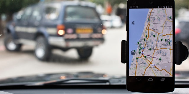 File photo: Anagog, an Israeli parking app, is seen on a smartphone in this photo illustration taken in Tel Aviv February 18, 2015. (REUTERS/Nir Elias)
