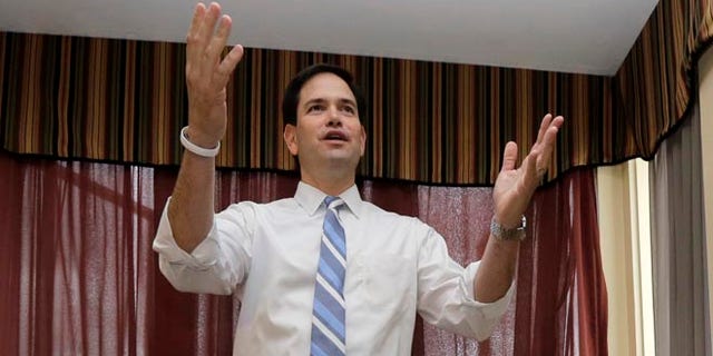 Republican presidential candidate, Sen. Marco Rubio, R-Fla., speaks to potential voters at a campaign house party, Friday, April 17, 2015, in Manchester, N.H. (AP Photo/Elise Amendola)