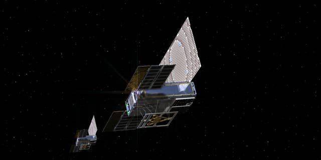 An artist's depiction of the tiny twin MarCO spacecraft on their way to Mars.