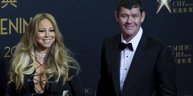 October 27, 2015. Singer Mariah Carey (L) and Australian billionaire James Packer, co-chairman of Melco Crown Entertainment, pose on the red carpet before the opening ceremony of Studio City in Macau, China.