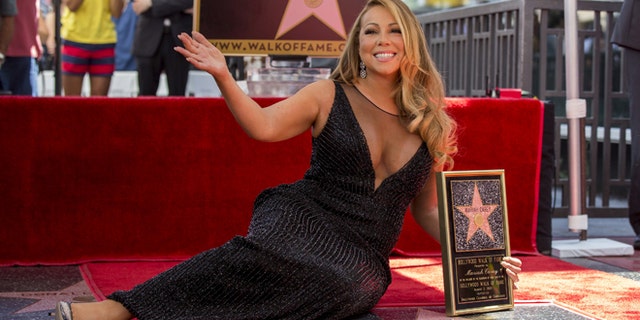 August 5, 2015. Mariah Carey poses with her star after it was unveiled on the Hollywood Walk of Fame in Los Angeles.
