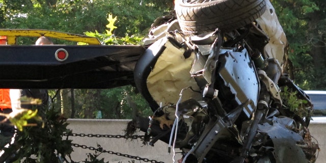 This Oct. 8, 2012 file photo shows the wrecked Subaru Impreza in which four people died as it is loaded onto a flatbed truck on the Southern State Parkway in West Hempstead, N.Y., after and early-morning accident. At the wheel was a New York teenager, Joseph Beer, who had smoked about $20 worth of marijuana, before getting into the car with four friends, and driving over 100 mph before crashing into trees with such force that it split the car in half. (AP Photo/Frank Eltman, File)