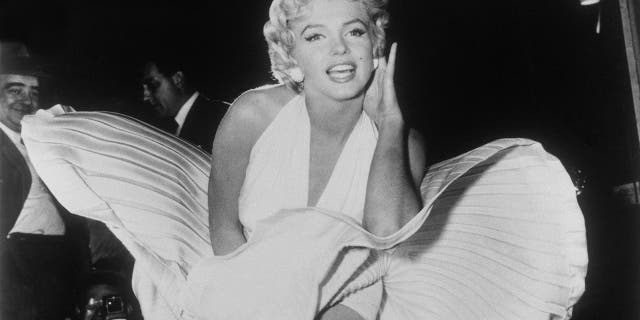 In this Sept. 9, 1954 file photo, Marilyn Monroe poses over the updraft of a New York subway grate while filming "The Seven Year Itch" New York. The dress, created by Bill Travilla, is one of several items that will be up for auction in October 2018.
