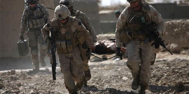 U.S. Marines carry a wounded Afghan soldier to a waiting medevac helicopter, in Marjah, Helmand province, Afghanistan.